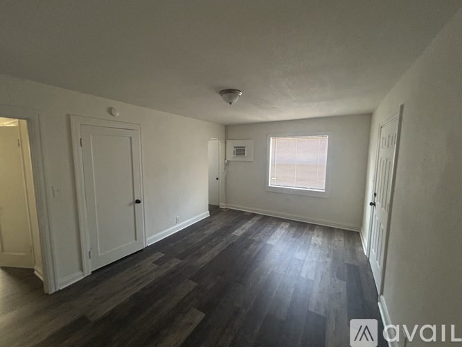 A room with wooden floors and white walls.