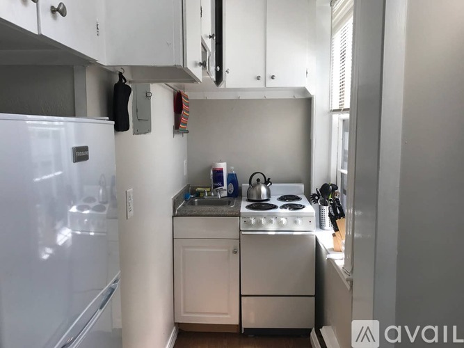 A small kitchen with a stove and a refrigerator.