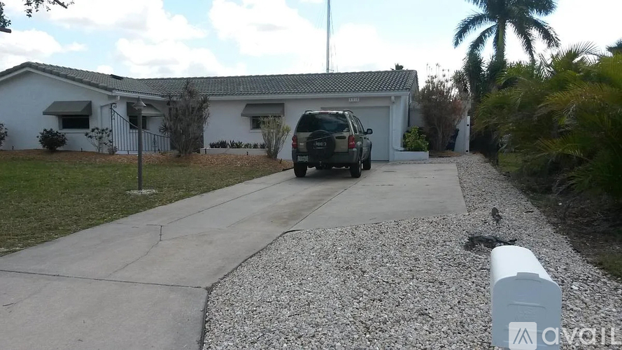 A house with a car parked in front of it.