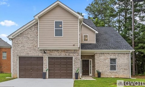 A house with a garage and a driveway is for sale.