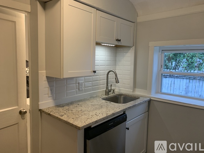 A kitchen with a sink and cabinets.