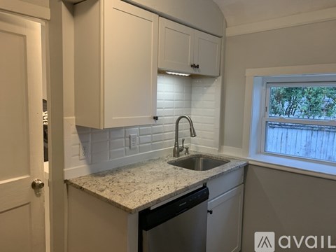 A kitchen with a sink and cabinets.