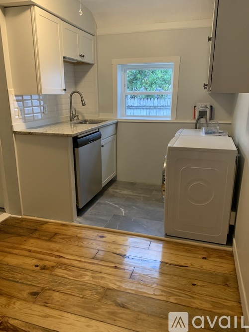 A kitchen with wooden floors and a window.