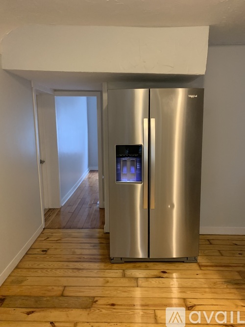 A stainless steel refrigerator with a digital display on the front.