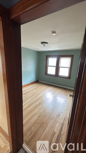 A room with wooden floors and a window.