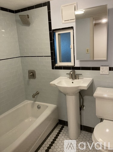 A bathroom with a white sink and toilet.