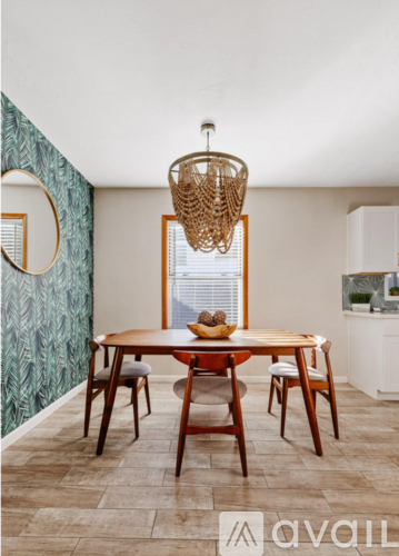 A dining room with a wooden table and chairs.