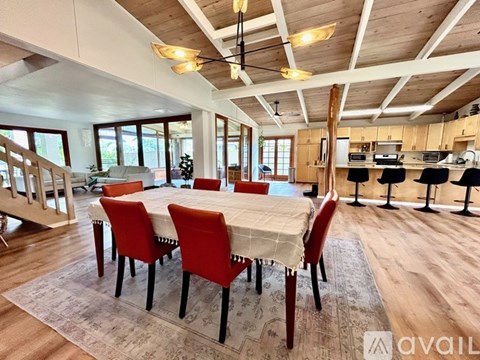 A dining room with a table and chairs.