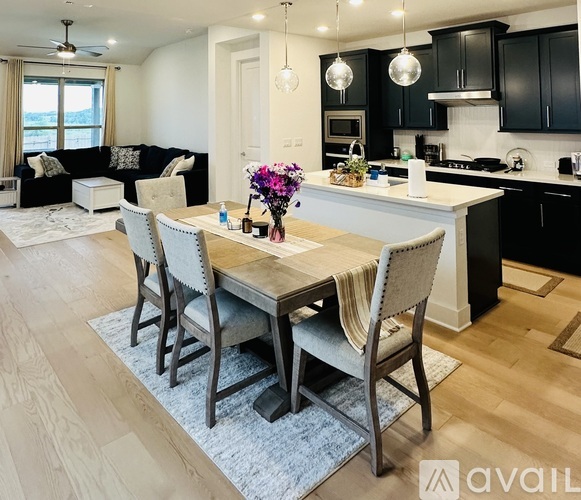 A modern kitchen with a dining table set for four.
