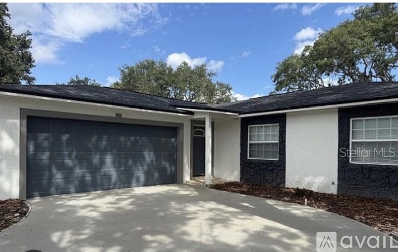 A two-story house with a garage is for sale.