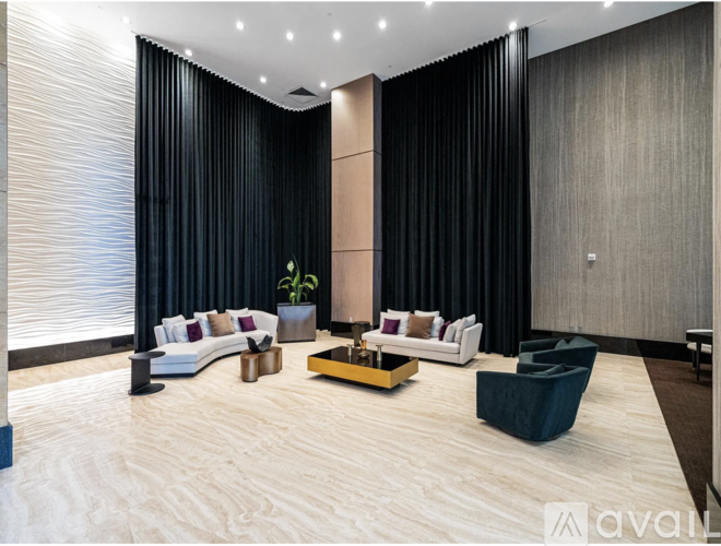 A modern living room with a large sofa set and a coffee table.