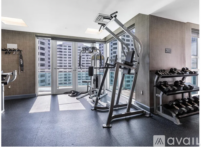 A gym with a view of a city skyline.
