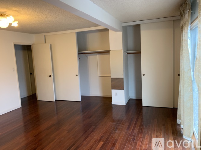 A room with wooden floors and white walls.