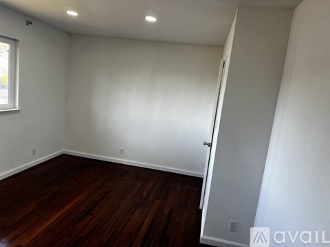 A room with wooden floors and white walls.