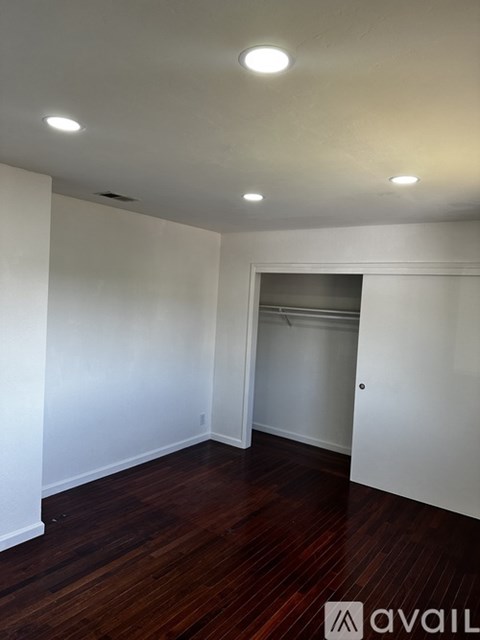 A room with wooden floors and white walls.