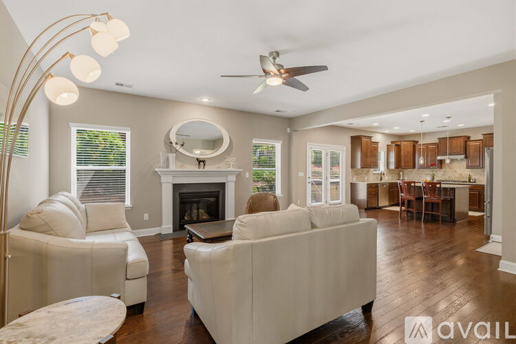 A living room with a white couch and a fireplace.