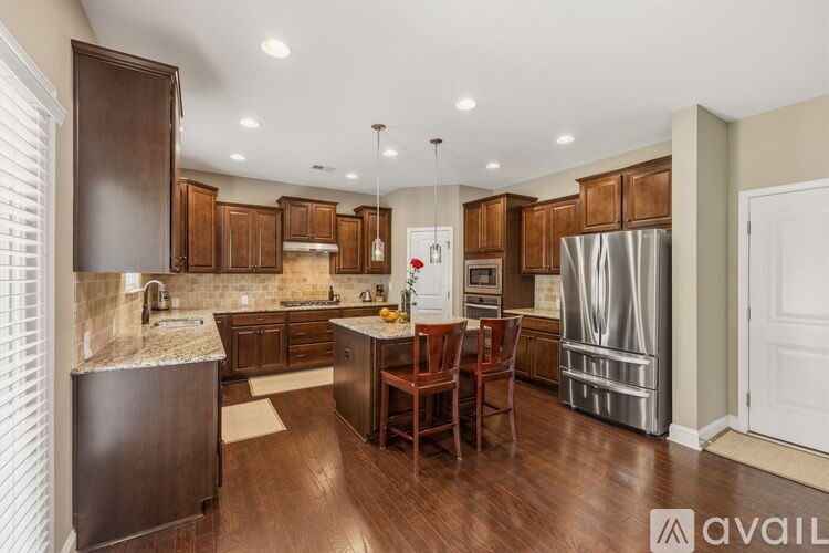 A kitchen with wooden cabinets and a central island.