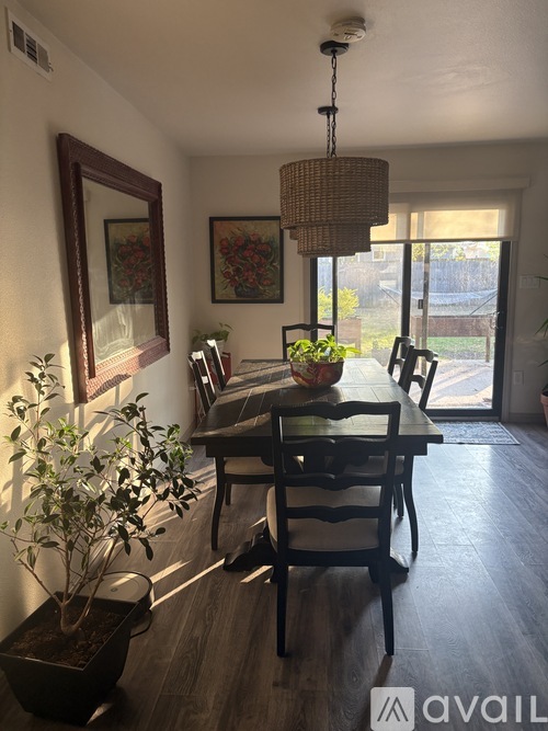 A dining room with a table and chairs.