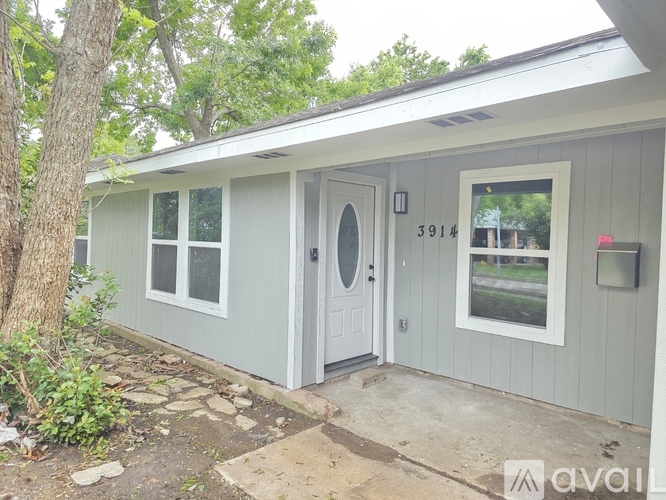 A small house with a white door and a window is numbered 3914.