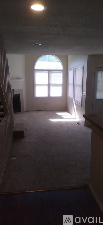 A room with a large window and a fireplace.