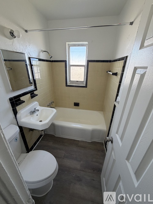 A bathroom with a toilet, sink, and bathtub.