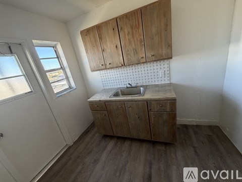 A small kitchen with wooden cabinets and a sink.