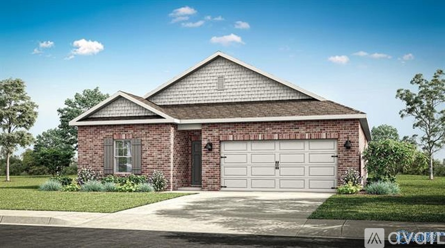A two-car garage is attached to a brick house.