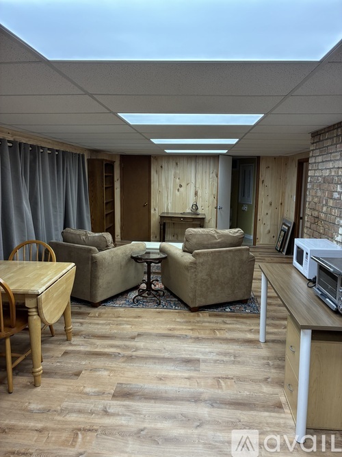 A living room with a wooden floor and furniture.