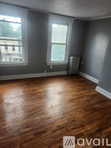 A room with wooden floors and a window.