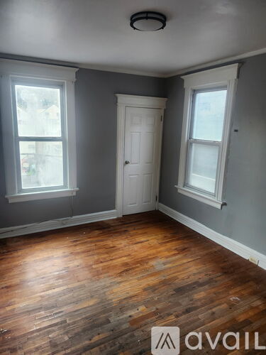 A room with wooden floors and a white door.