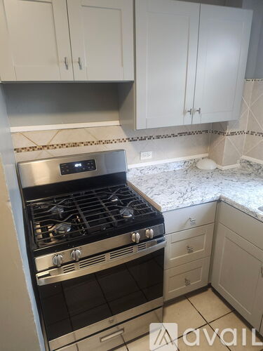 A kitchen with a stove and cabinets.