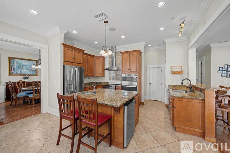 A kitchen with wooden cabinets and granite countertops.