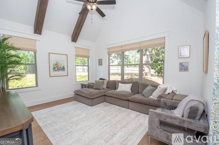 A living room with a grey couch and a wooden table.