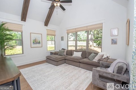 A living room with a grey couch and a wooden table.
