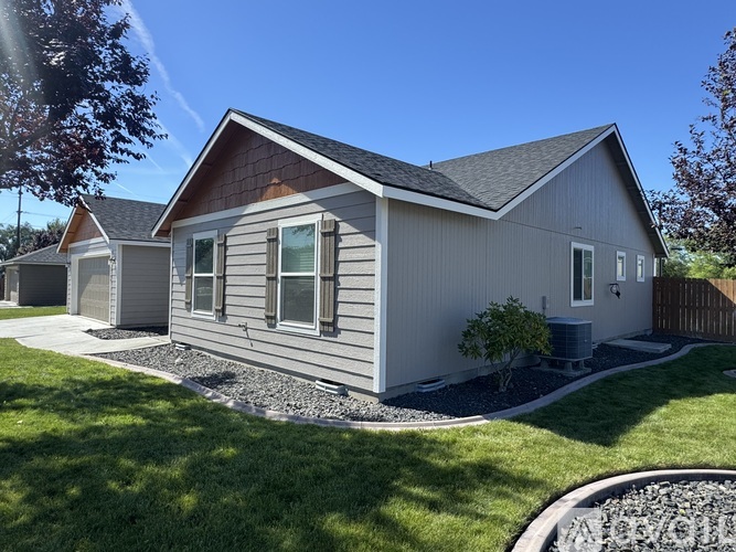 A house with a grey exterior and a brown roof.
