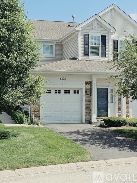 A two-story house with a garage is numbered 4370.