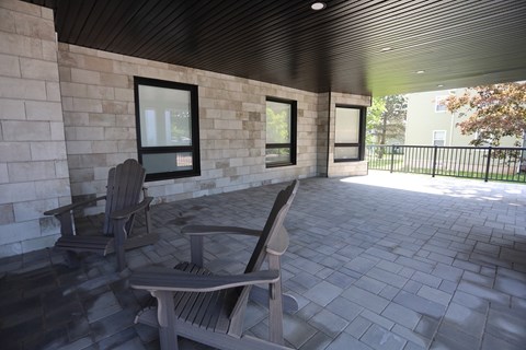 A patio with a bench and a table.