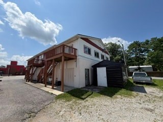 A two-story house with a garage and a car parked in front.