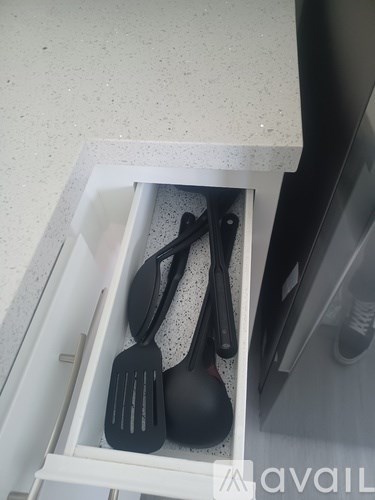 A drawer with utensils in it.
