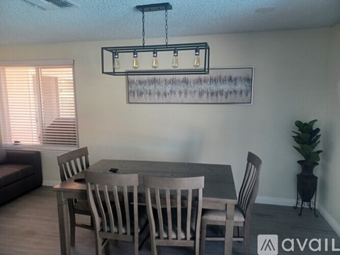 A dining room with a table and chairs.