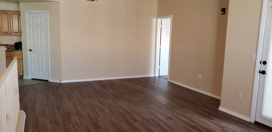A room with brown floors and white walls.