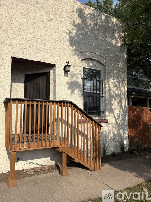 A white house with a wooden balcony.