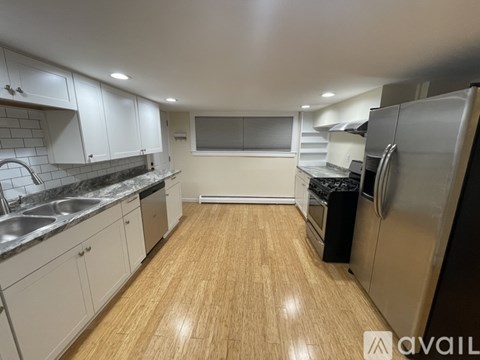 A kitchen with wooden floors and stainless steel appliances.