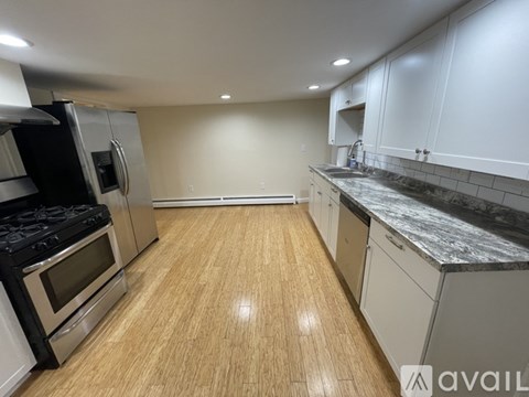 A kitchen with a stove top oven and a refrigerator.