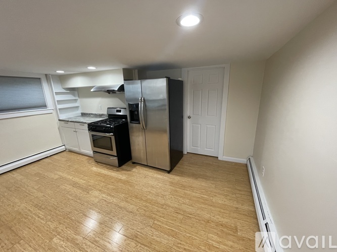 A kitchen with a stove, oven, and refrigerator.