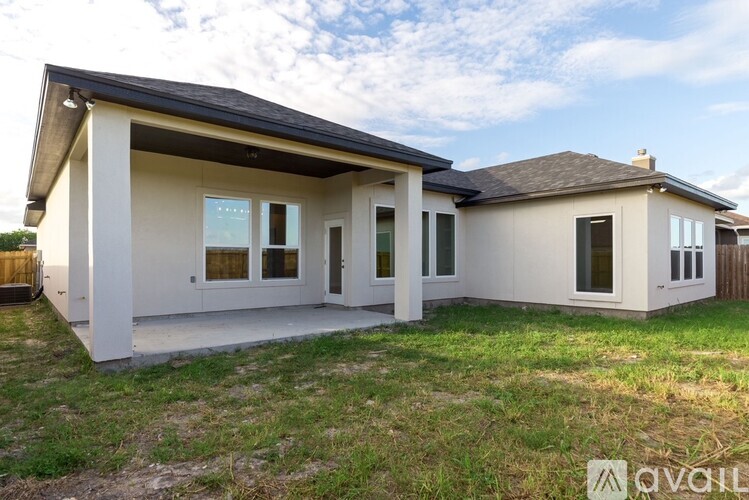 A house with a white exterior and a brown roof is available for sale.