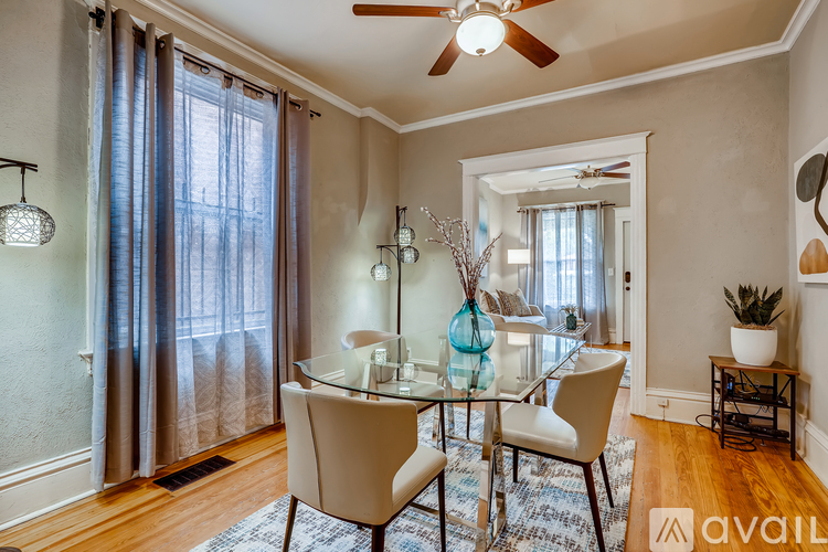 A dining room with a glass table and chairs.
