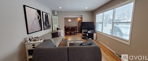 A living room with a grey couch and a television.