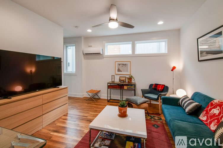 A living room with a television, a sofa, and a coffee table.