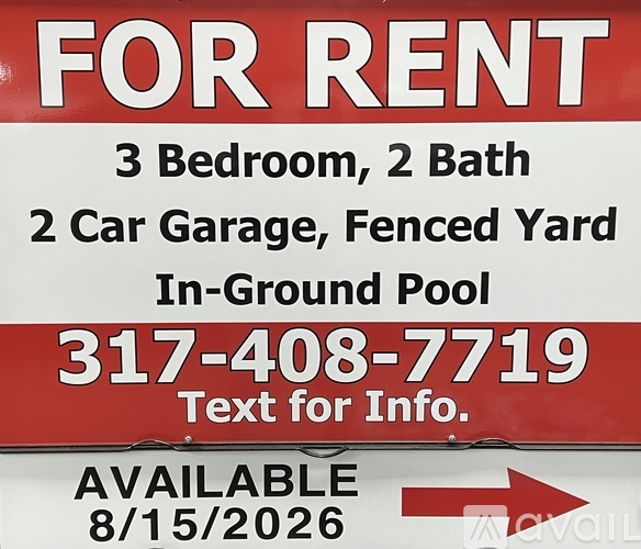 A red and white sign advertises a property for rent, including a 3 bedroom, 2 bathroom home with a 2 car garage and fenced yard.